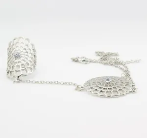 Close-up of silver hollow floral hand harness with sparkling rhinestone center detail