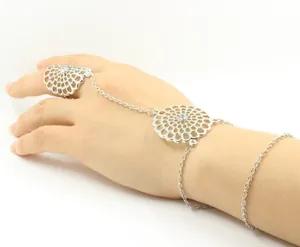 Detailed view of bohemian hollow flower hand chain with rhinestone accents on silver metal