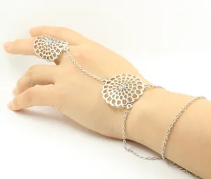 Detail of silver hollow flower finger bracelet with sparkling rhinestones on hand