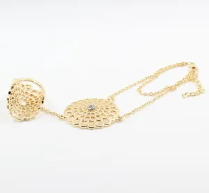 Detailed view of a gold-plated flower ring bracelet with sparkling rhinestone center