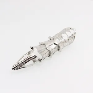Detailed close-up of punk armor knuckle ring with heart cutouts and metal textures