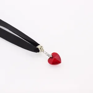 Gothic black velvet choker necklace featuring a faceted red crystal heart pendant