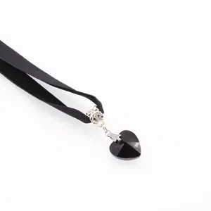Elegant black velvet choker necklace featuring a faceted heart-shaped crystal pendant