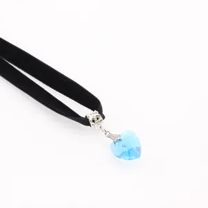 Lace velvet choker with faceted sky blue heart crystal pendant on white background