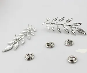 Close-up of silver leaf feather earrings showing intricate vein textures and metallic shine
