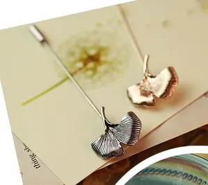 Artistic ginkgo leaf brooch in silver and bronze finish with detailed vein texture