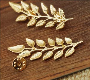 Exquisite golden leaf pins featuring detailed texture and a secure butterfly clutch backing