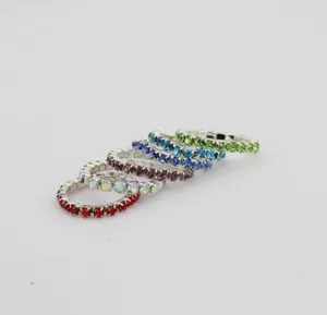 Close-up of elastic rhinestone rings set featuring six vibrant colors with silver-tone base