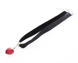 Detail of red crystal heart pendant on double-layer black velvet choker with silver clasp