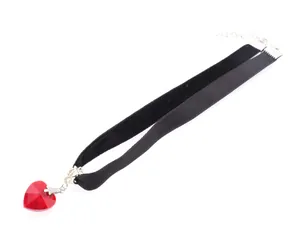 Detail of black velvet choker featuring a faceted red crystal heart and silver clasp
