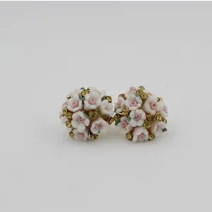 Chic pink and white ceramic flower stud earrings with sparkling crystals in gold setting