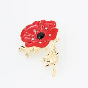 Detail of red enamel poppy brooch with gold trim, black gemstone center and crystals