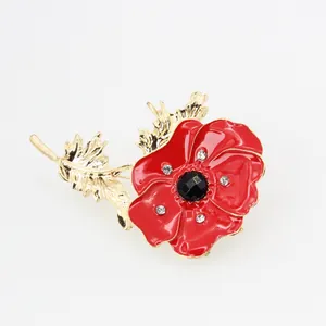 Red poppy flower brooch with enamel petals, gold finish and black gemstone center