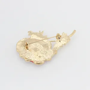 Detail view of the secure rotating clasp and textured golden metal back of the floral brooch