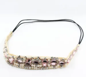Detailed view of handmade beaded headband with pink rhinestones and white pearls on mesh