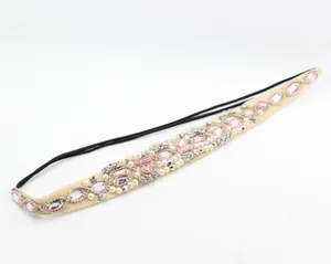 Detailed macro view of handmade headband with pink crystals, white pearls and mesh
