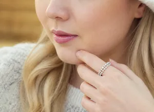 Close-up of double-row rhinestone elastic ring in silver finish on model finger