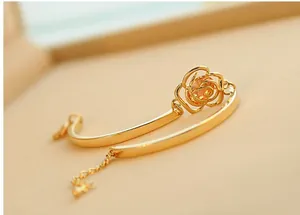 Detailed shot of a gold rose bracelet featuring a central yellow crystal and adjustable chain