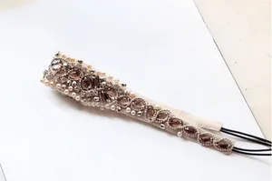 Detail of beaded headband featuring white pearls, brown gemstones, and intricate beadwork