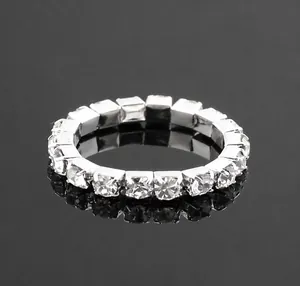 Close-up of elastic silver eternity ring with rows of shining rhinestones in macro view