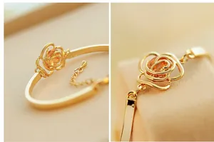 Detailed view of a gold rose bangle featuring a hollow flower with a yellow crystal center