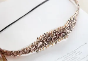Detailed close-up of handmade headband featuring crystal beads and faux pearls