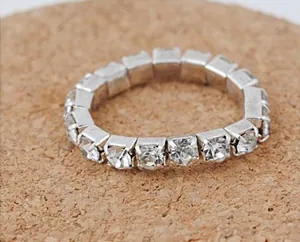 Macro shot of a silver stretch ring with single row of square cut sparkling rhinestones