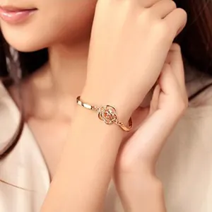 Elegant rose gold hollow rose bracelet with crystal accents on a female wrist