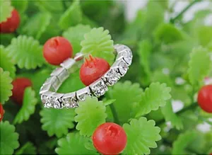 Close-up of sparkling silver elastic rhinestone ring with brilliant multi-row crystals