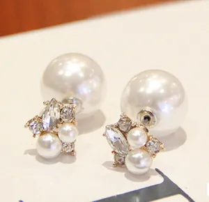 Detailed close-up of gold double-sided pearl earrings with sparkling rhinestones