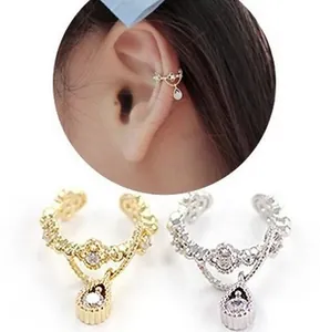 Ear cuffs con circonita en forma de gota y textura de corona en acabados oro y plata