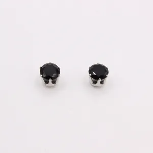 Detail showing classic round black zircon stud earrings with silver six-prong setting