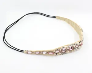 Exquisite handmade headband with pink gems, white pearls, and crystals on beige fabric
