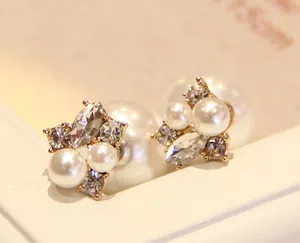 Detail of double-sided pearl earrings featuring rhinestones and a floral cluster design