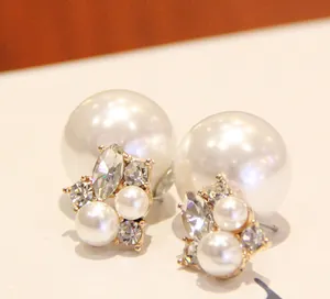 Detailed close-up of double-sided pearl earrings with crystals in gold-toned alloy