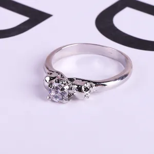 Silver skull ring with crystal zircon and punk gothic relief detailing on white background