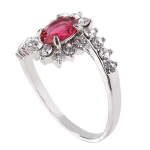 Close-up of vintage oval ruby ring with glittering pavé cubic zirconia set in silver