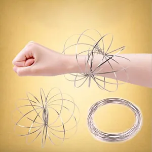 Silver metal magic flow ring for stress relief shown in both flat and 3D spherical forms