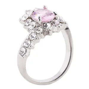 Elegant silver halo ring featuring a large oval pink gemstone surrounded by sparkling zirconias