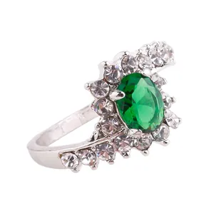 Detailed view of silver ring featuring oval green gemstone and pavé rhinestones