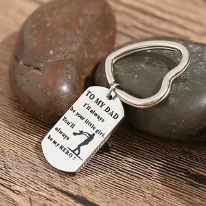 Stainless steel dog tag keychain with heart ring and engraved dad tribute on wood