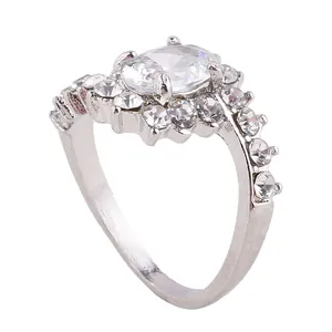 Macro shot of silver ring with oval clear gemstone and sparkling crystal pave details