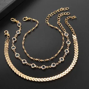 Three-piece golden anklet set featuring herringbone chain, crystal gems and beads decoration