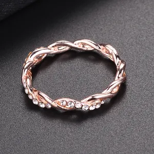 Rose gold twisted ring with sparkling crystals for women in minimalist elegant style