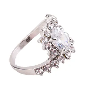 Macro shot of silver ring with oval crystal and pavé rhinestones in prong setting