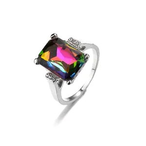 Macro shot of silver ring featuring rectangle iridescent crystal and clear side stones