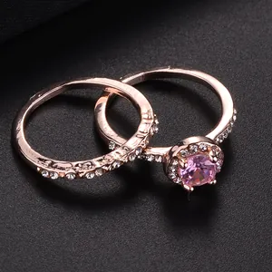 Two-piece rose gold ring set featuring round pink crystal and pavé white diamonds