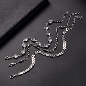 Detailed view of silver triple-layered anklet featuring crystal and fishbone chain texture