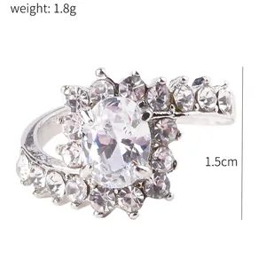 Detailed view of silver bypass ring with oval zircon and dimensions measuring 1.5cm