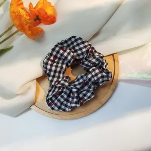 Cute black and white gingham scrunchie with red cherry pattern for girl hair styling